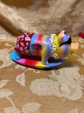 Ron Jon surf shop snorting pig on a surfboard